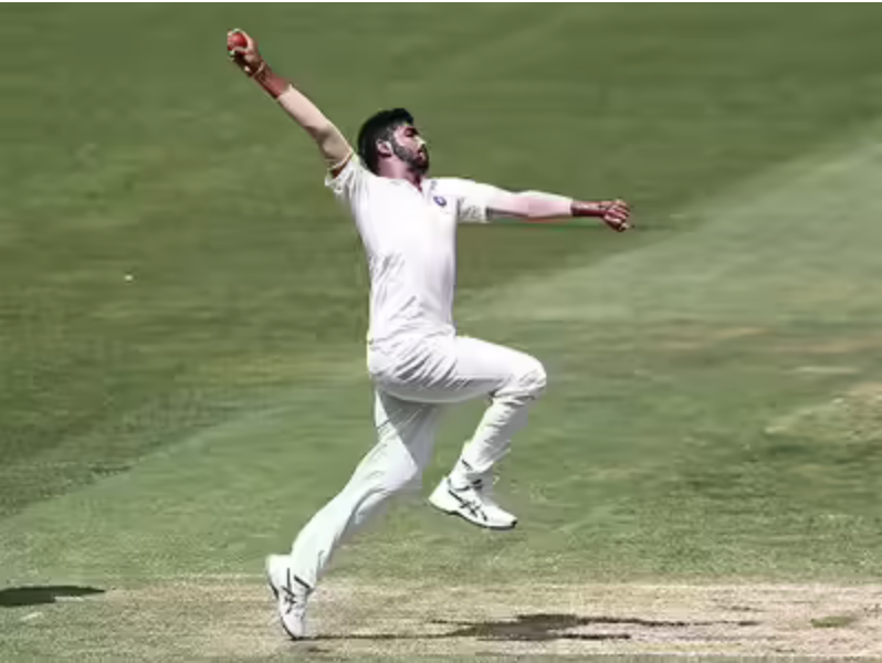 Jasprit Bumrah bowling action shot showing his unique hyperextended release and braced front foot.